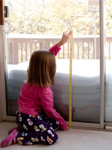 Lauren measuring snow