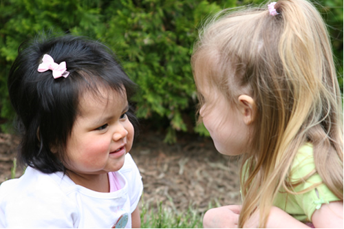 Lauren and Carmen sitting outside
